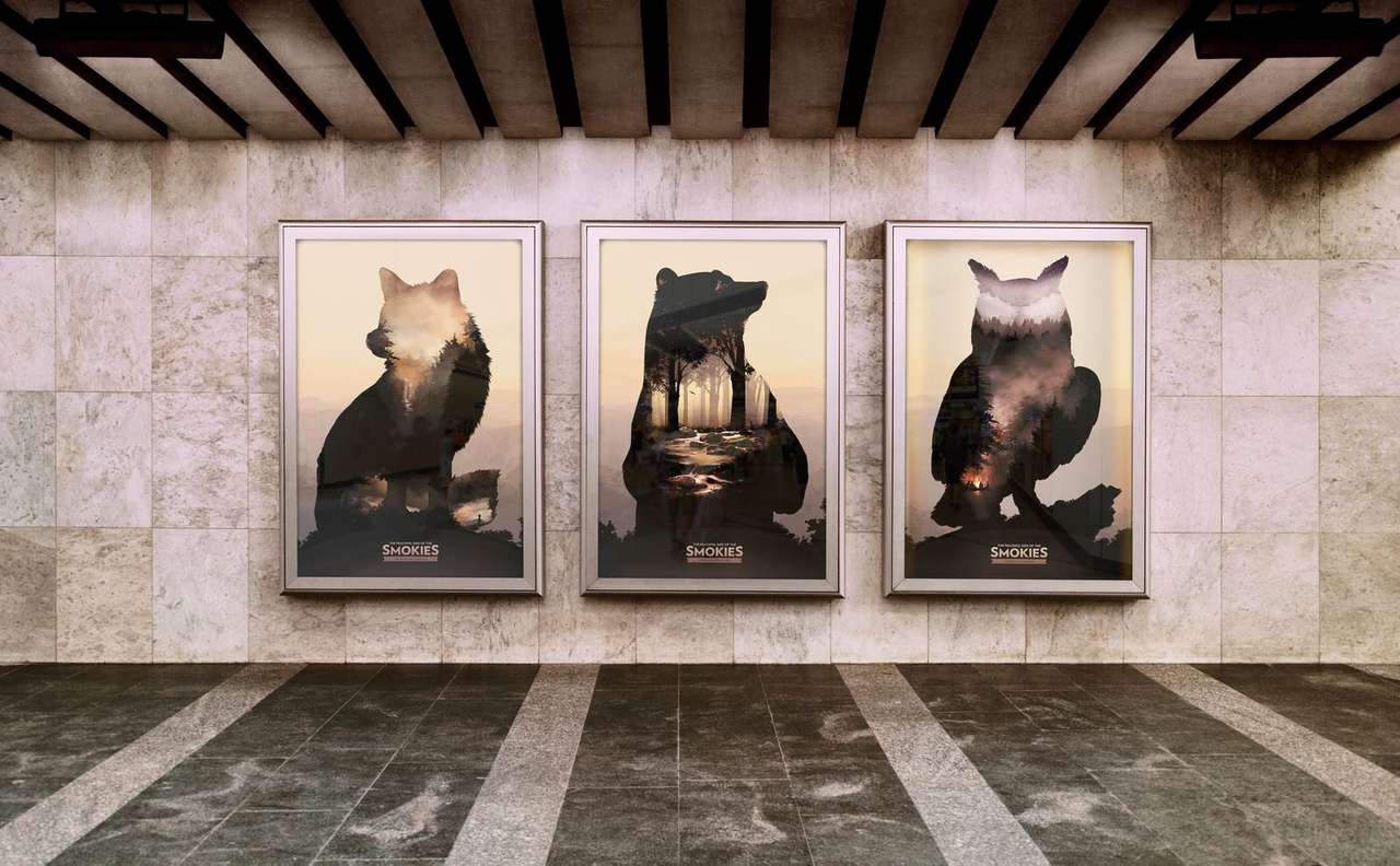 Peaceful Side of the Smokies wheatpaste poster series, fox, bear, and owl double-exposure key art framed on a station wall